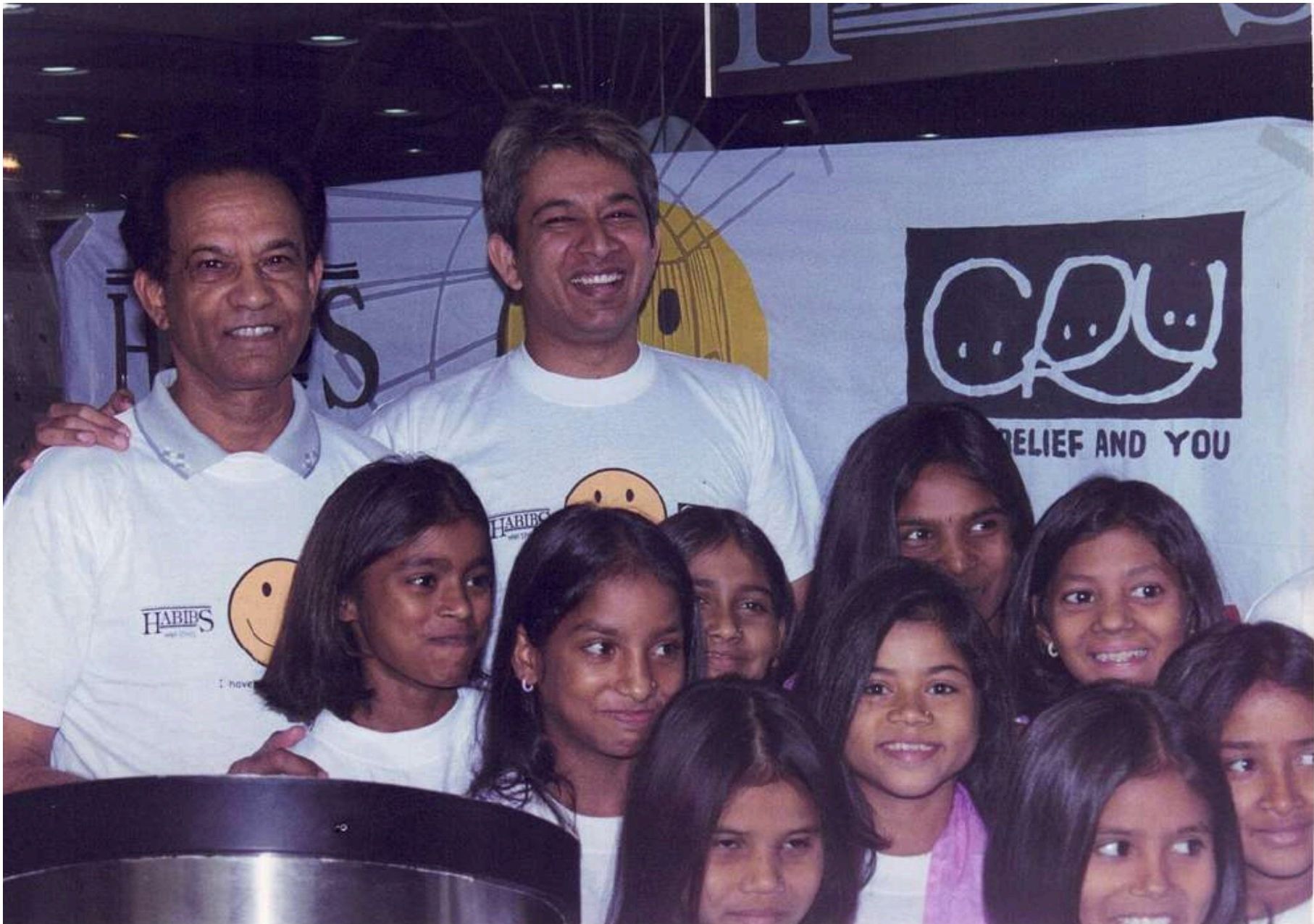 Jawed Habib with children at a CRY event