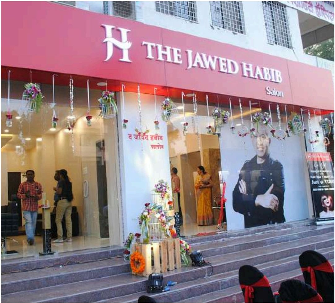 A new Jawed Habib salon opening, with red signage and decorations